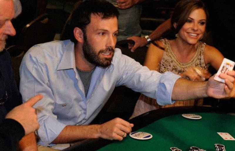 Ben Affleck holds a playing card